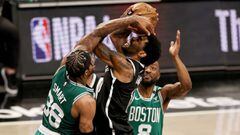 NEW YORK, NEW YORK - MAY 22: Kyrie Irving #11 of the Brooklyn Nets is fouled by Marcus Smart #36 of the Boston Celtics as Kemba Walker #8 of the Boston Celtics defends in the fourth quarter during Game One of their Eastern Conference first-round playoff s
