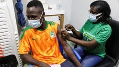 An Ivory Coast fan receives the vaccine against coronavirus disease (COVID -19) at a vaccination center, before watching the Africa Cup of Nations soccer match between Equatorial Guinea and Ivory Coast on a big screen in Abidjan, Ivory Coast January 12, 2