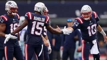 FOXBOROUGH, MASSACHUSETTS - OCTOBER 17: Nelson Agholor #15 and Mac Jones #10 of the New England Patriots slap hands before a game against the Dallas Cowboys at Gillette Stadium on October 17, 2021 in Foxborough, Massachusetts.   Maddie Meyer/Getty Images/