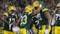 GREEN BAY, WISCONSIN - DECEMBER 12: Aaron Jones #33 of the Green Bay Packers celebrates with Marcedes Lewis #89 after scoring a three-yard rushing touchdown against the Chicago Bears during the third quarter of the NFL game at Lambeau Field on December 12