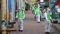 Health workers disinfect a street to curb the spread of coronavirus in Daegu. 