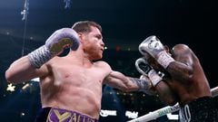 LAS VEGAS, NEVADA - SEPTEMBER 30: Saul "Canelo" Alvarez of Mexico (purple/gold trunks) trades punches with�Jermell Charlo (black trunks)�during their�super middleweight title fight at T-Mobile Arena on September 30, 2023 in Las Vegas, Nevada.   Sarah Stier/Getty Images/AFP (Photo by Sarah Stier / GETTY IMAGES NORTH AMERICA / Getty Images via AFP)