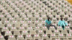 Fans sit on marked seats to adhere to social distancing measures to curb the spread of COVID-19 during the African Cup of Nations (AFCON) qualifying match between Nigeria and Lesotho at Teslim Balogun Stadium in Lagos on March 30, 2021. (Photo by PIUS UTO
