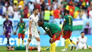 Soccer Football - FIFA World Cup Qatar 2022 - Group G - Cameroon v Serbia - Al Janoub Stadium, Al Wakrah, Qatar - November 28, 2022 Cameroon's Gael Ondoua and Serbia's Dusan Tadic react after the match REUTERS/Hannah Mckay