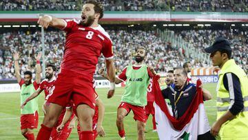 Syria&#039;s players celebrate at the end of their FIFA World Cup 2018 qualification football match against Iran at the Azadi Stadium in Tehran on September 5, 2017. / AFP PHOTO / ATTA KENARE