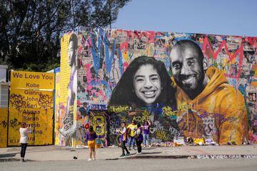 Fans gather around a mural of late NBA great Kobe Bryant and his daughter Gianna Bryant during a public memorial at the Staples Center in Los Angeles, California, U.S., February 24, 2020.