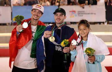 Ayrelien Giraud of France (C) celebrates with his gold medal, Ginwoo Onodera of Japan (R) celebrates his silver medal and Gustavo Ribeiro of Portgal (L) celebartes with his bronze medal, on the podium after the men's final in the Skateboarding Street World Championships 2023, at the Aljada skate park in Sharjah on February 5, 2023. (Photo by Karim SAHIB / AFP)