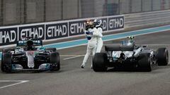 ABU DHABI, UNITED ARAB EMIRATES - NOVEMBER 26:  Second place finisher Lewis Hamilton of Great Britain and Mercedes GP celebrates on track with race winner Valtteri Bottas of Finland and Mercedes GP during the Abu Dhabi Formula One Grand Prix at Yas Marina Circuit on November 26, 2017 in Abu Dhabi, United Arab Emirates.  (Photo by Mark Thompson/Getty Images)