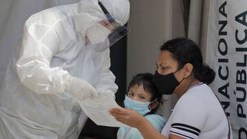 Medical staff attend to a mother and daughter outside the T-III Dr. Juan Duque de Estrada Health Centre in Mexico City. (Photo by Gerardo Vieyra/NurPhoto via Getty Images)