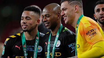 (L-R) Manchester City&#039;s Brazilian striker Gabriel Jesus, Manchester City&#039;s Brazilian midfielder Fernandinho and Manchester City&#039;s Brazilian goalkeeper Ederson celebrate with the trophy on the pitch after the English League Cup final footbal