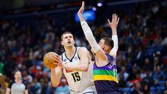 Denver Nuggets center Nikola Jokic (15) fights for position against New Orleans Pelicans center Jonas Valanciunas (17) during the first quarter at Smoothie King Center.