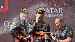 (L-R) Winner Red Bull Racing's Dutch driver Max Verstappen, third placed Red Bull Racing's Mexican driver Sergio Perez and Red Bull Racing chief engineer Paul Monaghan celebrate on the podium with Champagne after the Formula One Hungarian Grand Prix at the Hungaroring race track in Mogyorod near Budapest on July 23, 2023. (Photo by ATTILA KISBENEDEK / AFP)