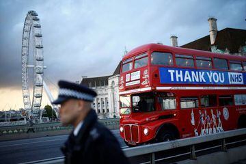 A bus displays a thank you message to the NHS on Westminster Bridge, London.