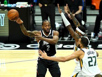Feb 19, 2021; Los Angeles, California, USA; Los Angeles Clippers forward Kawhi Leonard (2) looks to make a pass as Utah Jazz forward Royce O'Neale (23 and center Rudy Gobert (27) defend in the first quarter of the game at Staples Center. Mandatory Credit: