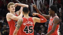 Jan 15, 2018; Chicago, IL, USA; Chicago Bulls forward Lauri Markkanen (left) reacts after scoring and being fouled against the Miami Heat as forward Denzel Valentine (45) and guard Justin Holiday (right) celebrate during the second half at United Center. 