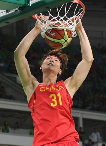 China's centre Wang Zhelin scores during a Men's round Group A basketball match between France and China at the Carioca Arena 1 in Rio de Janeiro on August 8, 2016 during the Rio 2016 Olympic Games