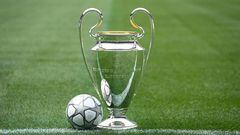 The Champions League trophy is seen with the official match ball