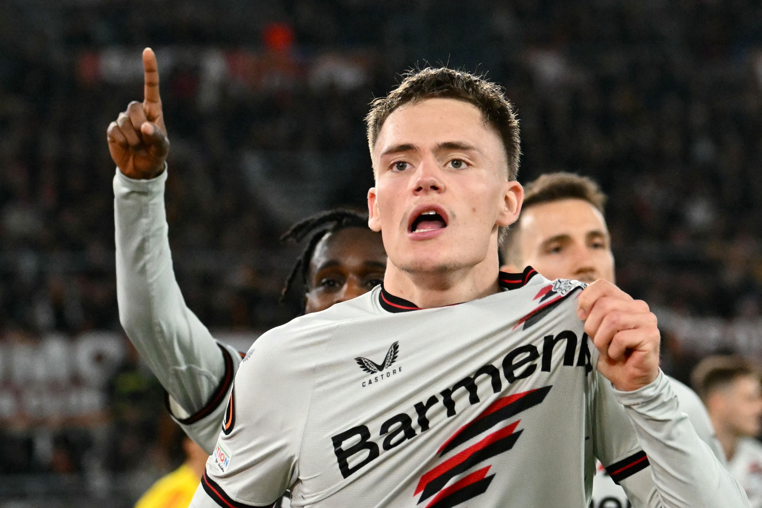 Bayer Leverkusen's German midfielder #10 Florian Wirtz celebrates with teammates after scoring his team first goal during the UEFA Europa League semi final first leg football match between AS Roma and Bayern Leverkusen at the Olympic stadium on May 2, 2024 in Rome. (Photo by Alberto PIZZOLI / AFP)