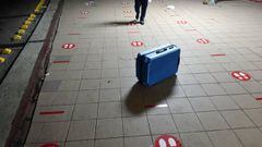 HAVANA, CUBA - JULY 31: An empty and broken suitcase stands left behind where the line for a flight from Havana to Ghana was, amidst stickers on the ground that mark the indicated social distancing, on July 31, 2020, in Havana, Cuba. Cuba has announced th