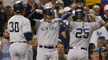 New York Yankees&#039; Gleyber Torres (25) celebrates his two-run home with Luke Voit, center, that also drove in Edwin Encarnacion during the second inning of a baseball game against the Boston Red Sox in Boston, Sunday, Sept. 8, 2019. (AP Photo/Michael 
