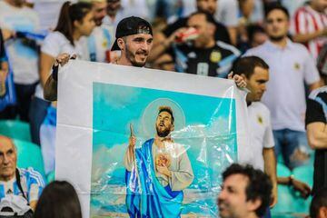 Blind faith? An Argentinian supporter holds a poster depicting Argentina's striker Lionel Messi as a saint.