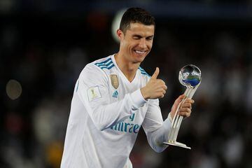 Real Madrid’s Cristiano Ronaldo celebrates with an award after the game
