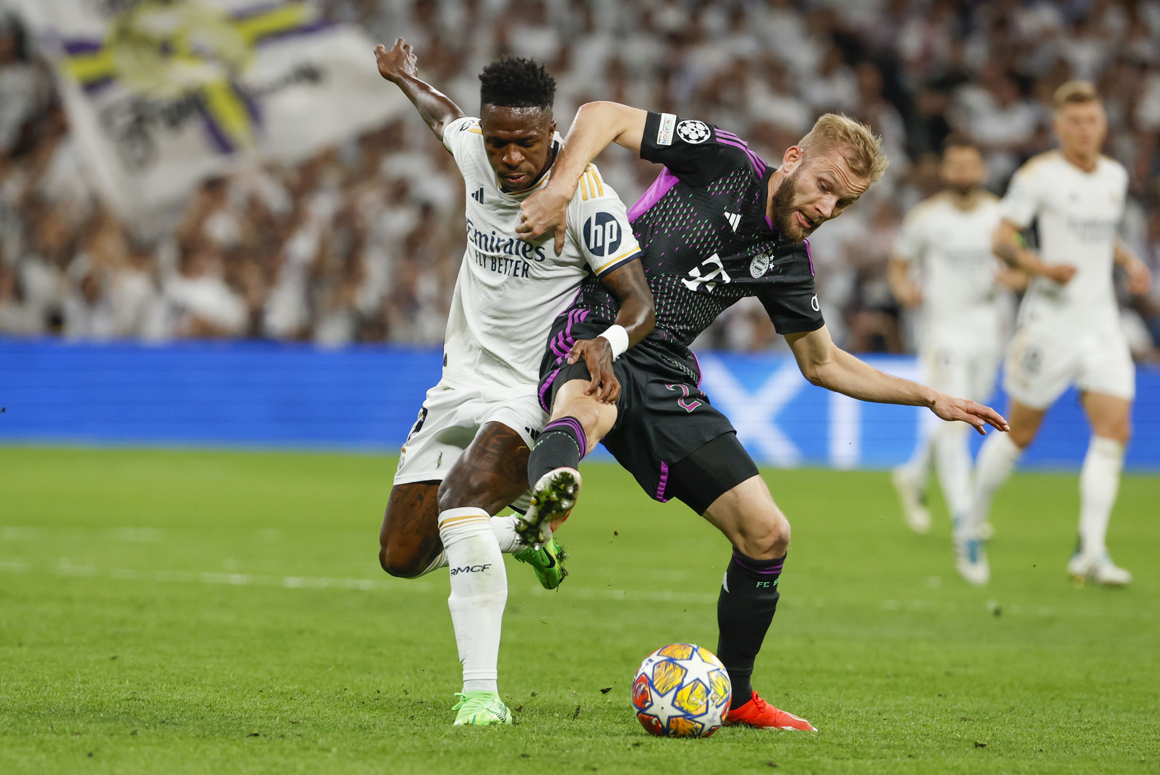 Real Madrid's Vinicius Junior and Bayern's Konrad Laimer