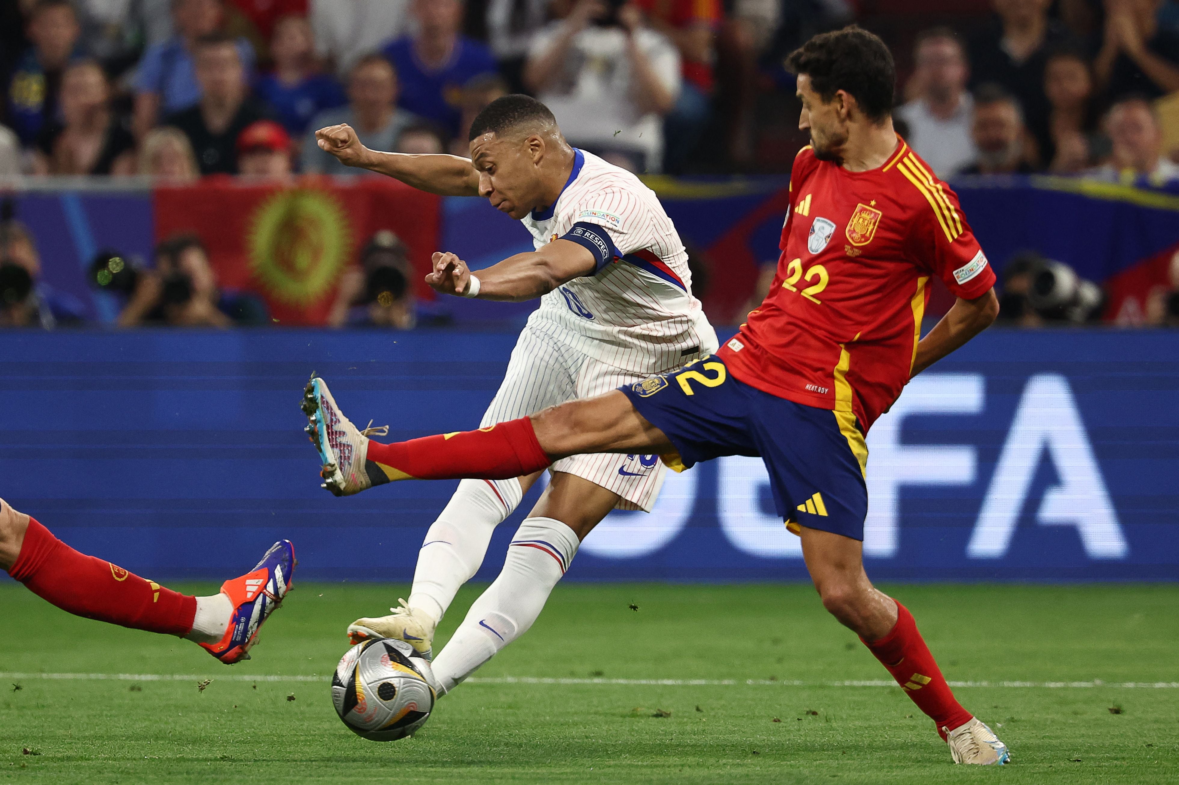 France's forward #10 Kylian Mbappe shoots on target next to Spain's forward #22 Jesus Navas during the UEFA Euro 2024 semi-final football match between Spain and France at the Munich Football Arena in Munich on July 9, 2024. (Photo by FRANCK FIFE / AFP)