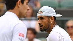 Australia's Nick Kyrgios (R) walks past Chile's Cristian Garin during their men's singles quarter final tennis match on the tenth day of the 2022 Wimbledon Championships at The All England Tennis Club in Wimbledon, southwest London, on July 6, 2022. (Photo by SEBASTIEN BOZON / AFP) / RESTRICTED TO EDITORIAL USE