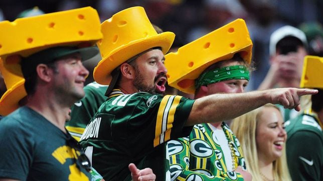 Green Bay Packers fans wearing team colours and cheesehead hat at