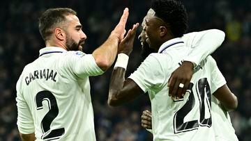 Real Madrid's Brazilian forward Vinicius Junior (R) celebrates scoring his team's second goal with Real Madrid's Spanish defender Dani Carvajal (L) and Real Madrid's German defender Antonio Rudiger during the Spanish league football match between Real Madrid CF and Valencia CF at the Santiago Bernabeu stadium in Madrid on February 2, 2023. (Photo by JAVIER SORIANO / AFP)