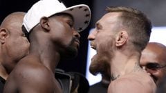(FILES) This file photo taken on August 25, 2017 shows boxer Floyd Mayweather Jr. (L) and MMA figher Connor Mcgregor during their weigh-in in Las Vegas, Nevada.   Floyd Mayweather and Conor McGregor&#039;s cross-combat superfight was the second richest b