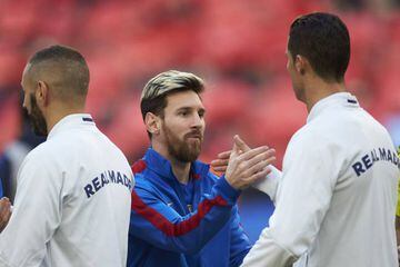 FC Barcelona's Lionel Messi with Real Madrid's Cristiano Ronaldo.