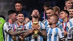 Argentina's defender #19 Nicolas Otamendi holds the FIFA World Cup Trophy as he celebrates with teammates winning the Qatar 2022 World Cup final football match between Argentina and France at Lusail Stadium in Lusail, north of Doha on December 18, 2022. (Photo by Kirill KUDRYAVTSEV / AFP)