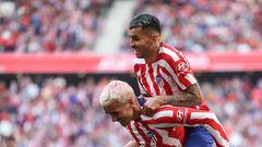 Atletico Madrid's Argentinian forward Angel Correa (Top) celebrates with Atletico Madrid's French forward Antoine Griezmann after scoring his team's third goal during the Spanish league football match between Club Atletico de Madrid and CA Osasuna at the Wanda Metropolitano stadium in Madrid on May 21, 2023. (Photo by Pierre-Philippe MARCOU / AFP)