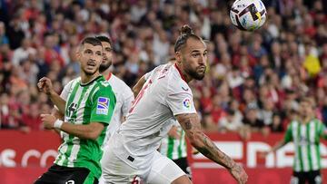 Real Betis' Argentinian midfielder Guido Rodriguez (L) vies with Sevilla's Serbian midfielder Nemanja Gudelj during the SPanish league football match between Sevilla FC and Real Betis at the Ramon Sanchez Pizjuan stadium in Seville on May 21, 2023. (Photo by CRISTINA QUICLER / AFP)