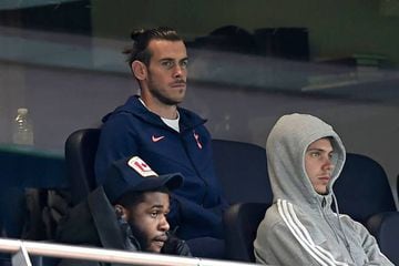 Gareth Bale (C) watches from his seat during the English Premier League football match between Tottenham Hotspur and Newcastle United.