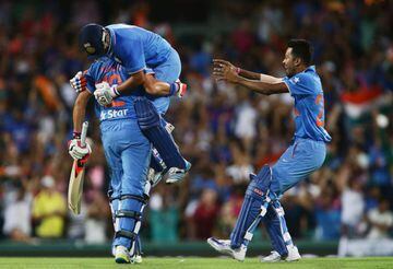 Suresh Raina of India (top) celebrates hitting the winning runs on the last ball of the match with Yuvraj Singh of India (bottom) during the International Twenty20 match between Australia and India at Sydney Cricket Ground.
