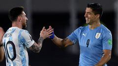 (FILES) Argentina's Lionel Messi (L) greets Uruguay's Luis Suarez before the start of the South American qualification football match for the FIFA World Cup Qatar 2022, at the Monumental stadium in Buenos Aires, on October 10, 2021. Uruguay's record goalscorer Luis Suarez on November 13, 2023, received his first call-up under new coach Marcelo Bielsa who named the 36-year-old in his squad to face Argentina on November 16, 2023, in a 2026 FIFA World Cup qualifier. If he plays, Suarez is likely to come up against his former Barcelona teammate Lionel Messi. (Photo by Juan MABROMATA / AFP)