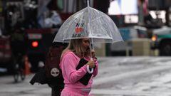 Una persona que lleva un paraguas camina por Time Square durante la lluvia en la ciudad de Nueva York el 23 de agosto de 2021. 
