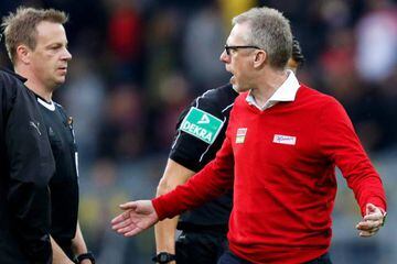 Cologne's head coach Peter Stoeger argues with a linesman during the German Bundesliga match against Borussia Dortmund.