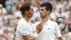(FILES) In this file photo taken on July 14, 2018 Serbia's Novak Djokovic (R) shakes hands after beating Spain's Rafael Nadal during the continuation of their men's singles semi-final match on the twelfth day of the 2018 Wimbledon Championships at The All England Lawn Tennis Club in Wimbledon, southwest London. - Novak Djokovic and Rafael Nadal headline the title chase at Wimbledon where eight-time champion Roger Federer, the world's top two players and cherished ranking points will all be missing. Djokovic is bidding for a seventh title at the All England Club to move level with US great Pete Sampras. Nadal, fresh from a 14th French Open victory and a record-extending 22nd major, is halfway to the first men's calendar Grand Slam in more than half a century. (Photo by NIC BOTHMA / POOL / AFP) / RESTRICTED TO EDITORIAL USE