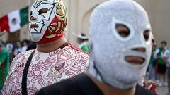 Mexico fans wearing a wrestling mask pose at the Katara Cultura Village during the Qatar 2022 World Cup football tournament in Doha on November 21