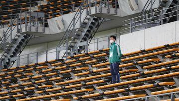 Soccer Football - World Cup Qualifiers Asia - Round 2 - Group F - Mongolia v Japan - Fukuda Denshi Arena, Chiba, Japan - March 30, 2021 A member of staff in an empty stand before the match REUTERS/Issei Kato