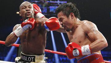 Floyd Mayweather Jr., left, faces off with Manny Pacquiao, from the Philippines, during their welterweight title fight on Saturday, May 2, 2015 in Las Vegas. (AP Photo/John Locher)