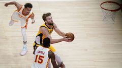 Indiana Pacers Domantas Sabonis, center, shoots against Atlanta Hawks&#039; Trae Young, left, and Clint Capela, right, during the first half of an NBA basketball game on Sunday, April 18, 2021, in Atlanta. (AP Photo/Brynn Anderson)