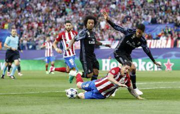 Raphael Varane brings down Atlético striker Fernando Torres to concede a penalty.