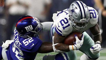 ARLINGTON, TX - SEPTEMBER 16: Ezekiel Elliott #21 of the Dallas Cowboys is tackled by Alec Ogletree #52 of the New York Giants in the second quarter at AT&amp;T Stadium on September 16, 2018 in Arlington, Texas.   Ronald Martinez/Getty Images/AFP == FOR 