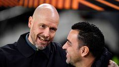 Manchester United's Dutch manager Erik ten Hag (L) speaks with Barcelona's Spanish coach Xavi during the UEFA Europa League round of 32 first-leg football match between FC Barcelona and Manchester United at the Camp Nou stadium in Barcelona, on February 16, 2023. (Photo by Pau BARRENA / AFP)