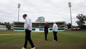 Umpires and ground staff inspect the playing surface in Durban. 